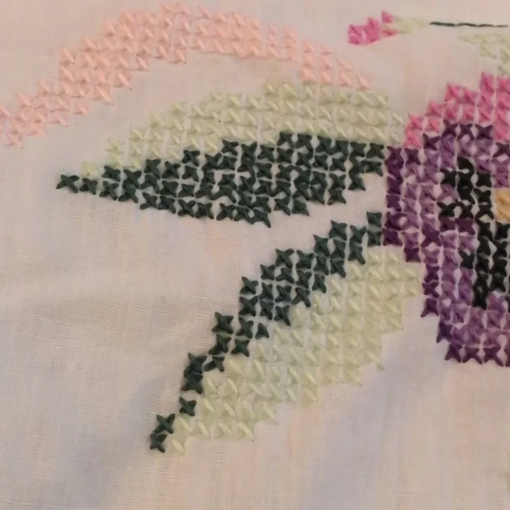 Vintage white pillowcase with embroidered purple‎ flowers